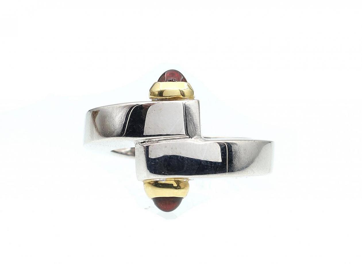 Industrial 18kt white gold cross over ring with garnet cabochon terminals