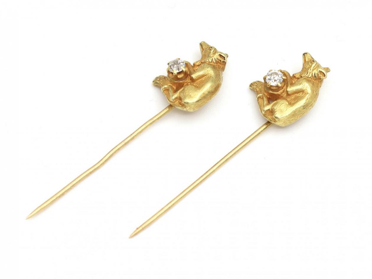 Matching pair of diamond set wolf stick pins in yellow gold