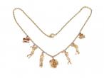 1960s 18kt gold golfing charm necklace with diamond, coral and enamel