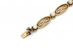 French 18kt yellow gold infinity bracelet set with pearls