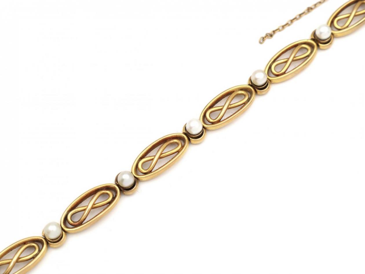 French 18kt yellow gold infinity bracelet set with pearls