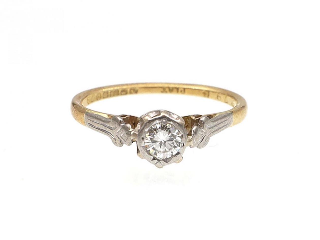 Antique diamond solitaire ring with fleur de lis shoulders
