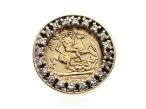 Vintage 9kt yellow gold coin ring with a border of cubic zirconias
