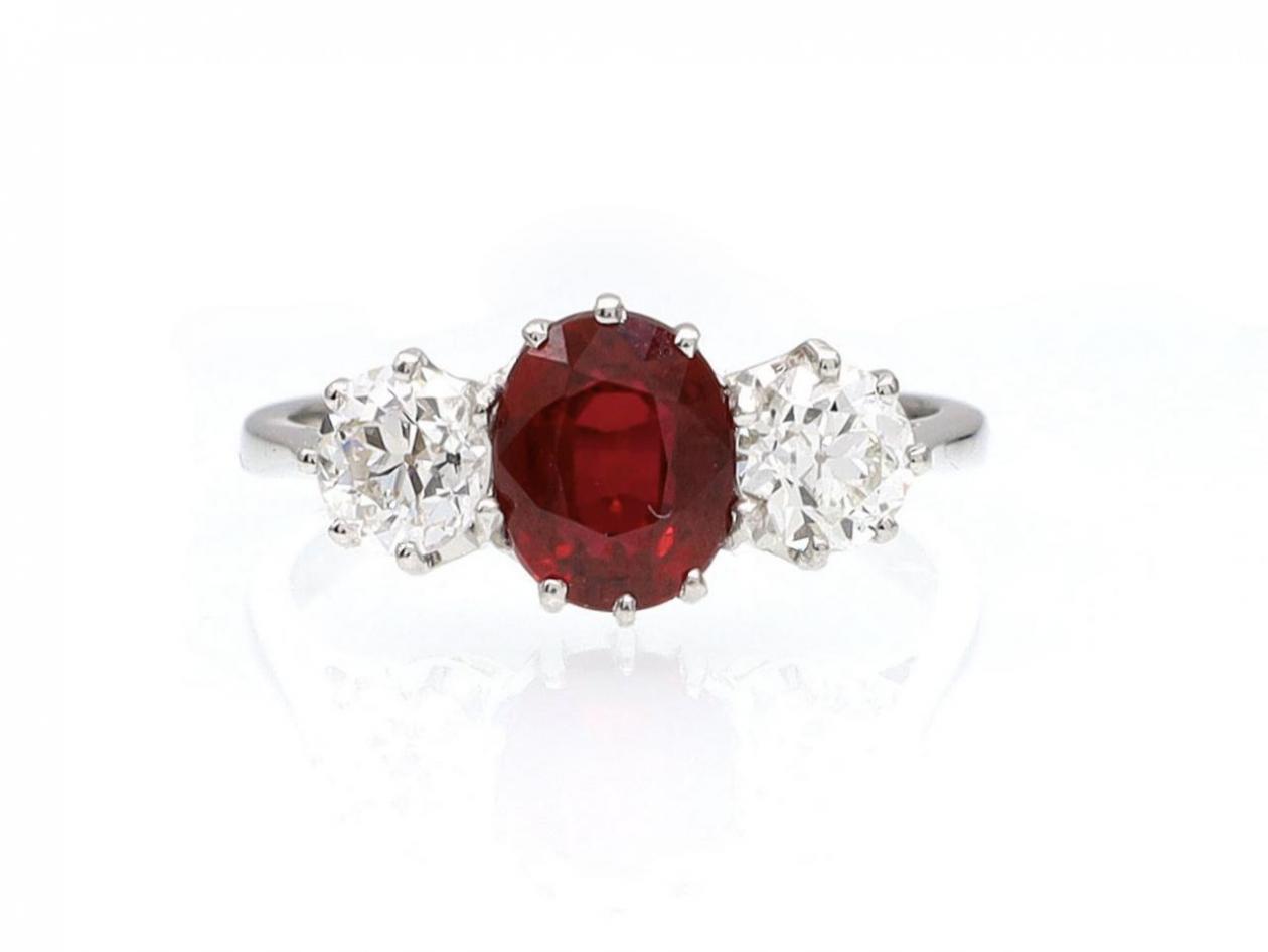 Contemporary oval ruby and diamond three stone ring