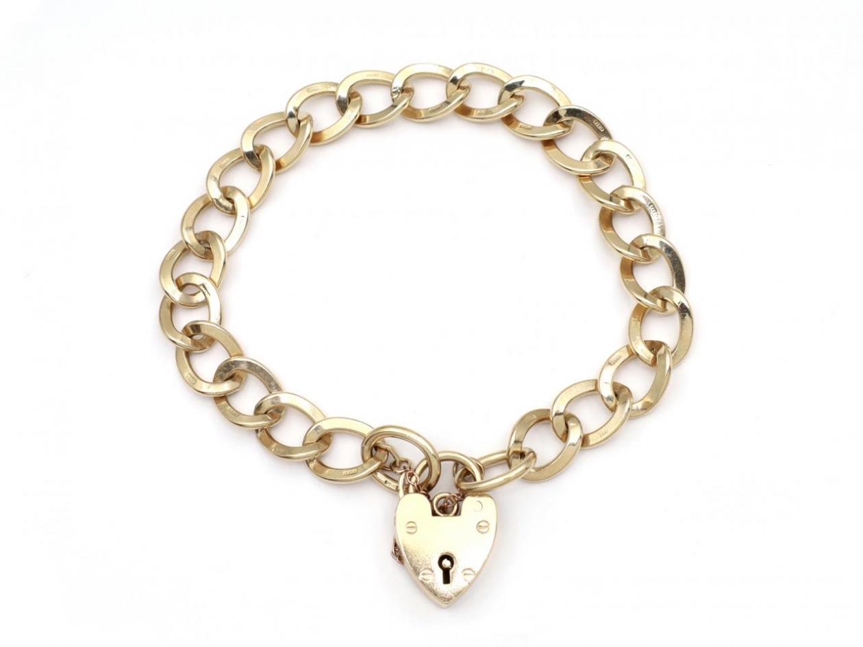 1967 oval curb link heart lock bracelet in yellow gold