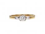 Flanked diamond solitaire engagement ring in 18kt yellow gold