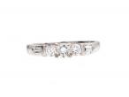 Diamond flanked solitaire engagement ring in 18kt white gold