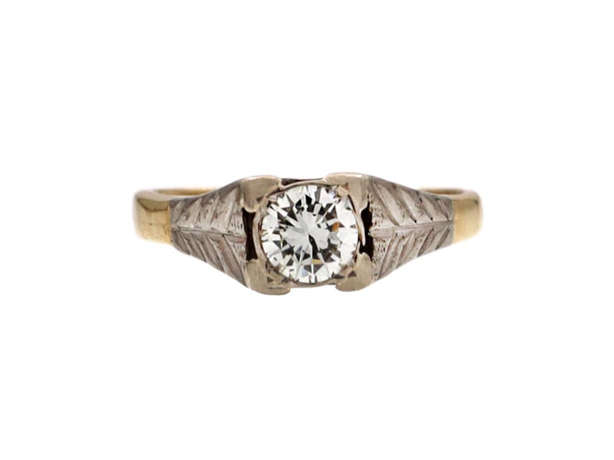 Antique diamond solitaire engagement ring with leaf motifs