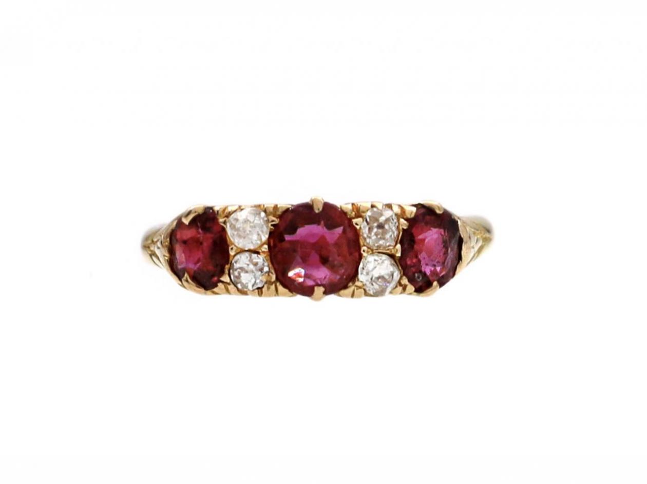 1889 ruby and diamond three stone carved ring in 18kt yellow gold