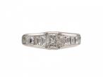 Rectangular diamond flanked solitaire engagement ring in platinum