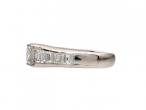 Rectangular diamond flanked solitaire engagement ring in platinum