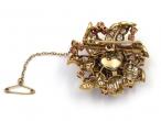 Retro diamond and ruby flower brooch in 18kt yellow gold