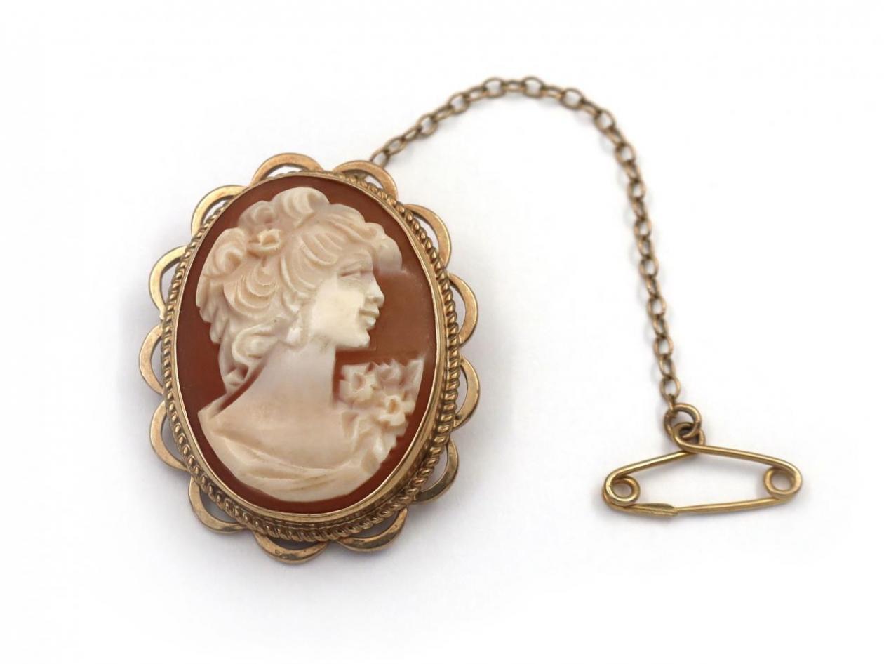 Vintage shell cameo brooch featuring the portrait of a lady