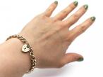 1989 hollow curb link bracelet with heart lock in 9kt yellow gold