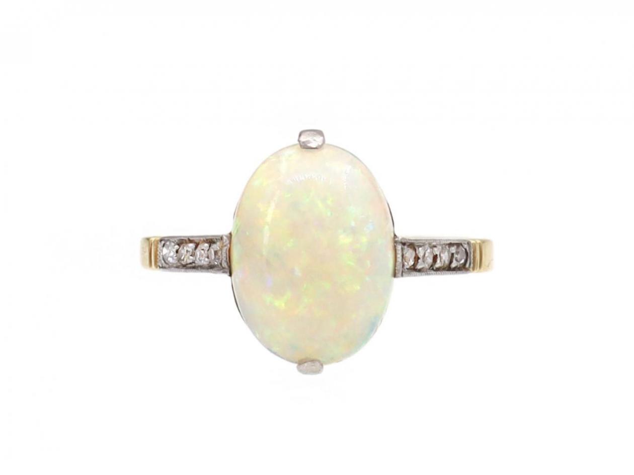 Edwardian oval opal solitaire ring with diamond shoulders
