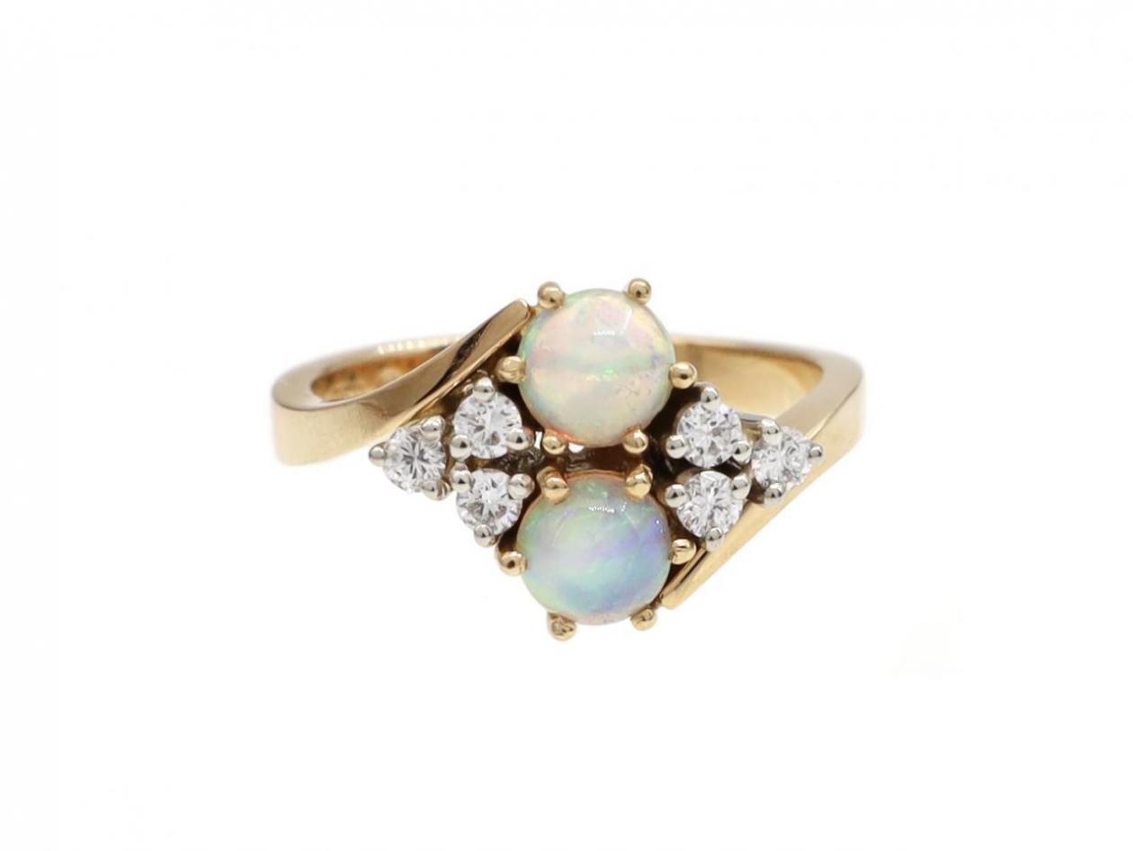 Retro two stone opal and diamond crossover ring in 18kt yellow gold