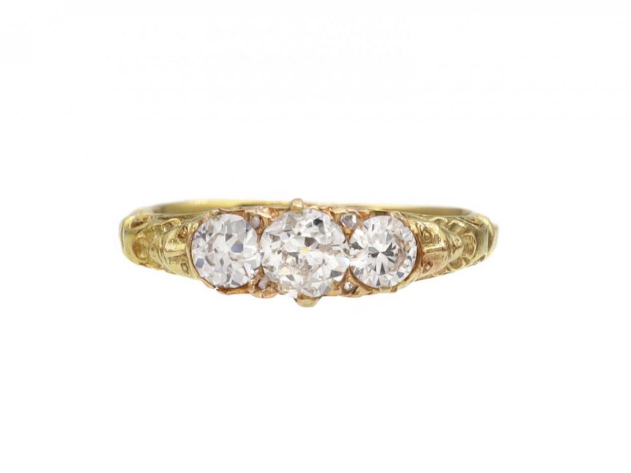 Antique carved faces diamond three stone ring in 18kt yellow gold