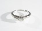 Platinum diamond flanked solitaire ring