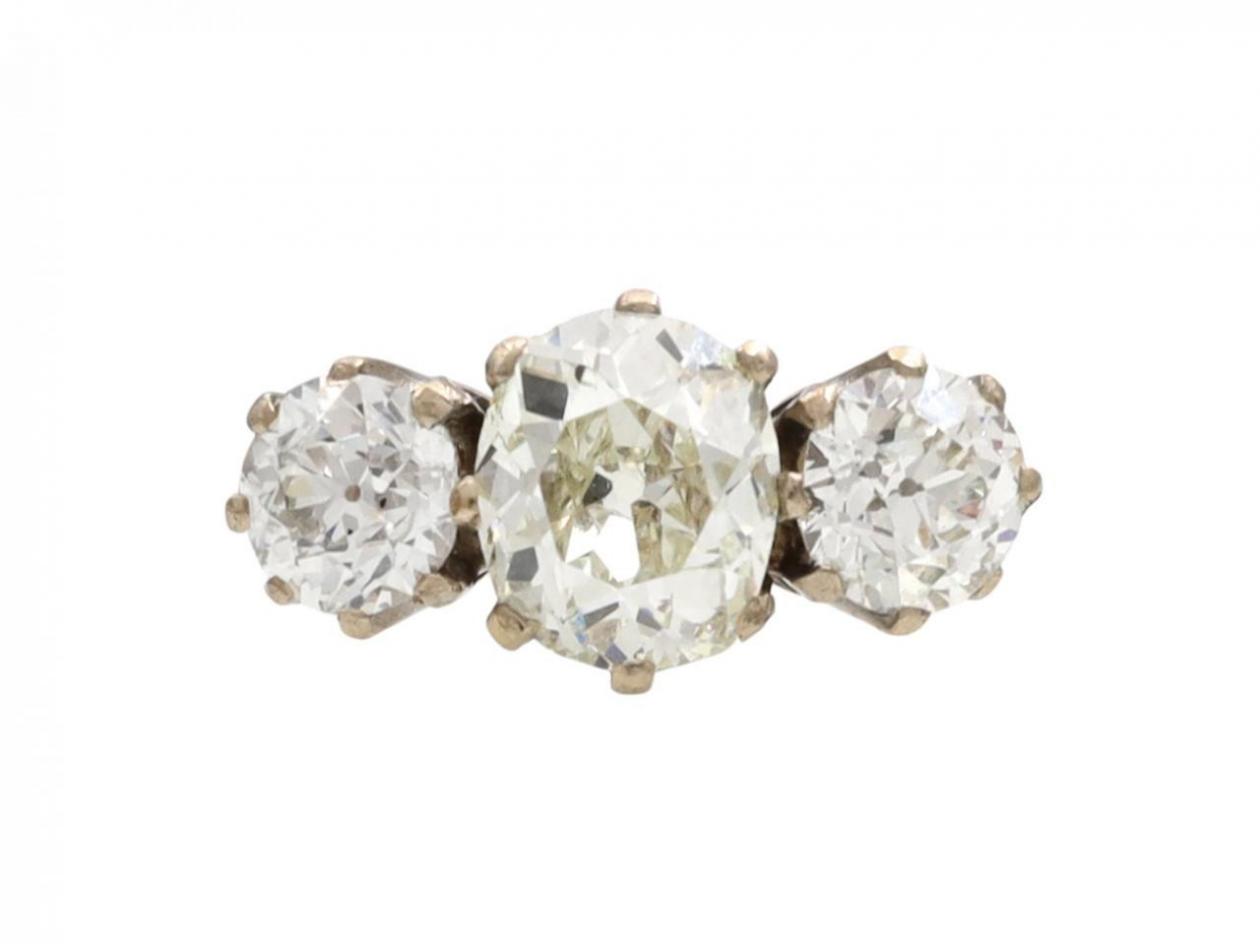 Antique oval three stone diamond engagement ring in yellow gold