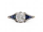 Vintage 1.03ct round diamond solitaire ring with calibre cut sapphire shoulders