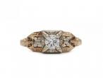 Vintage diamond solitaire engagement ring with floral motifs in gold