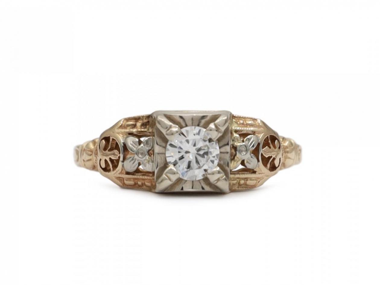 Vintage diamond solitaire engagement ring with floral motifs in gold