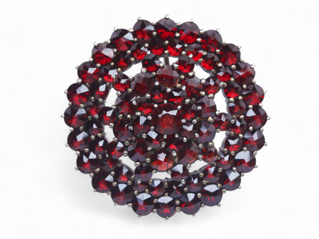 Antique silver gilt brooch set with rose-cut garnets in a domed circular cluster