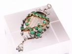 Emerald and diamond harp brooch in yellow gold and silver with articulated diamond drop.