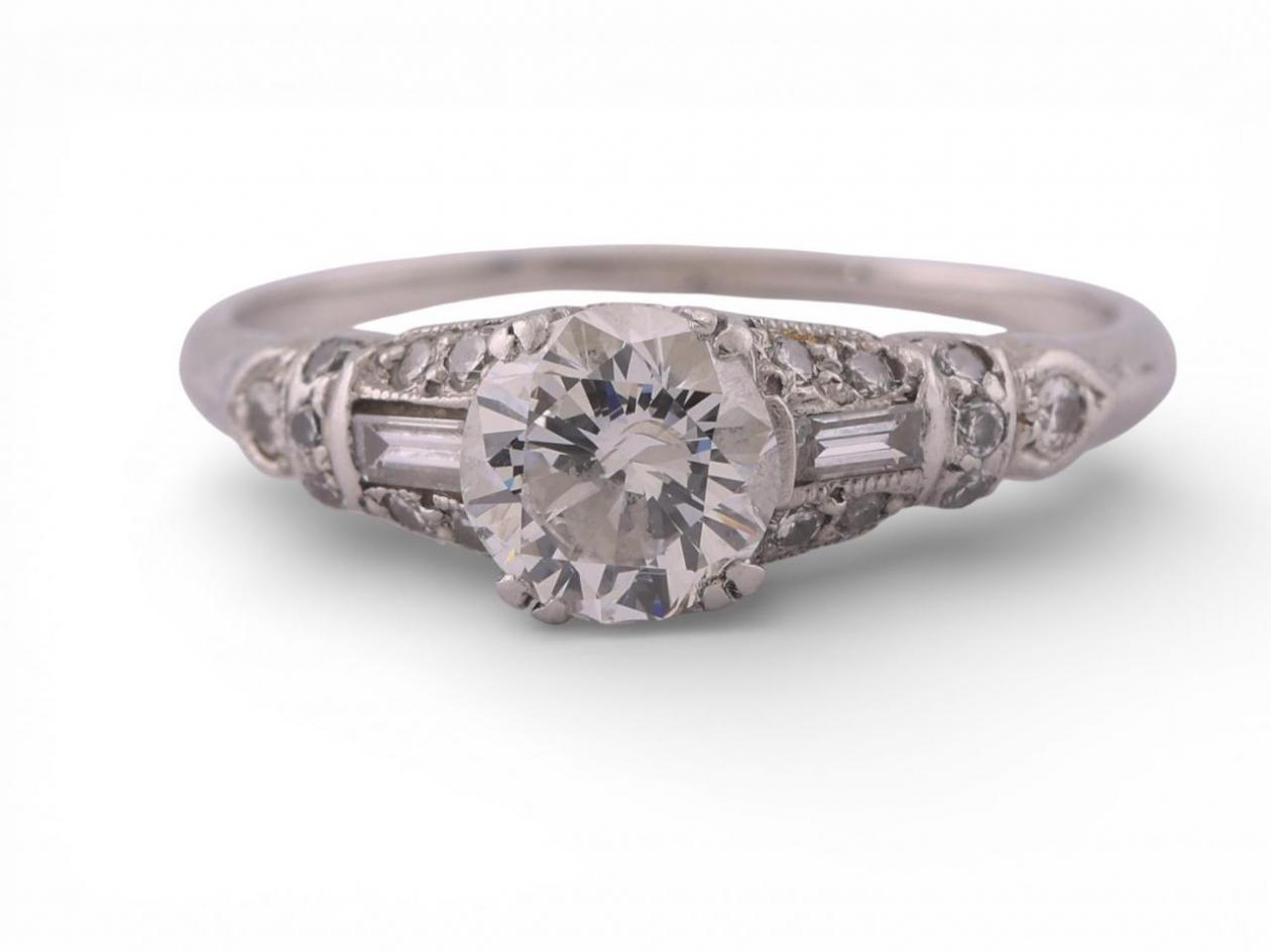 Art Deco Platinum Diamond Solitaire Ring with Baguette and Round AccentsArt Deco Platinum Diamond Solitaire Ring with Baguette and Round Accents