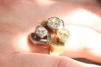 Vintage three-stone diamond monochromatic cocktail ring featuring a crossover design, circa 1960