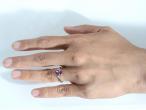 Pink sapphire solitaire ring with diamond set shoulders