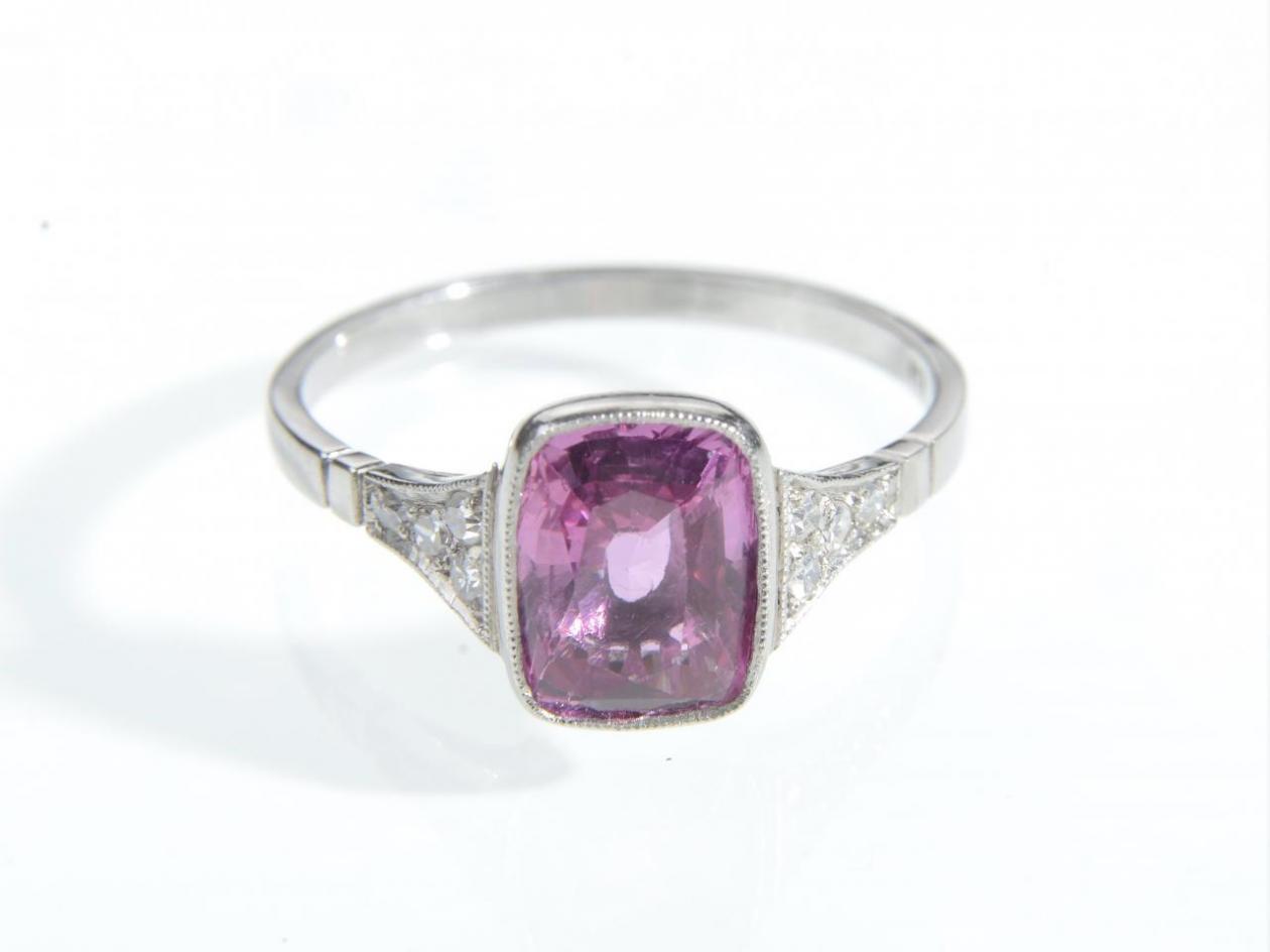Pink sapphire solitaire ring with diamond set shoulders