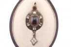 RENAISSANCE REVIVAL GARNET, CHRYSOBERYL AND ENAMEL HOLBEINESQUE PENDANT, CIRCA 1870.