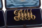 LATE VICTORIAN GOLD AND SEED-PEARL MONOGRAM BROOCHES, CIRCA 1890