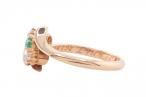 EDWARDIAN EMERALD AND DIAMOND THREE-STONE CROSSOVER RING, 1909