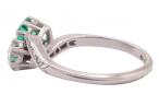 EDWARDIAN DIAMOND AND EMERALD CROSS-OVER RING, CIRCA 1910
