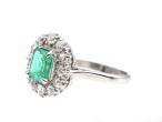 Vintage emerald and diamond oval cluster ring in platinum