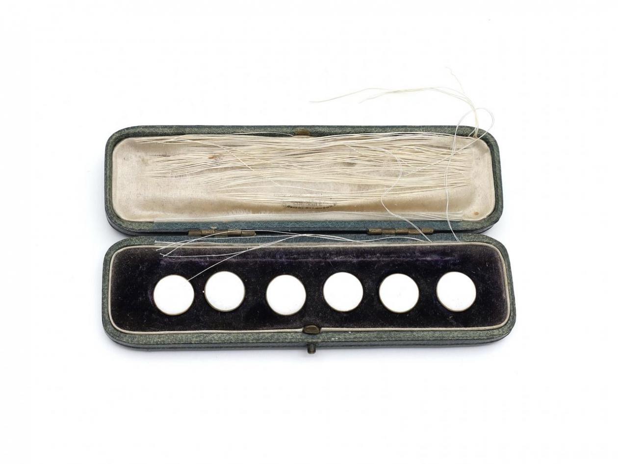 Antique set of round white enamel buttons