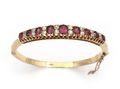 Antique ruby and diamond hinged bangle in yellow gold
