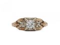 Vintage diamond solitaire engagement ring with floral motifs in gold