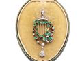 Emerald and diamond harp brooch in yellow gold and silver with articulated diamond drop.