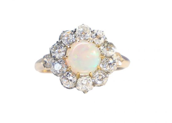 A Victorian cluster ring featuring a cabochon opal