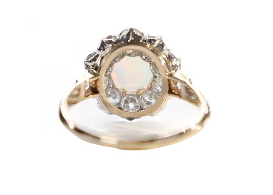A Victorian cluster ring featuring a cabochon opalA Victorian cluster ring featuring a cabochon opalA Victorian cluster ring featuring a cabochon opal